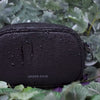 Anti-theft Water-resistant Myko Crossbody demonstrating water-resistance with water droplets falling down the bag