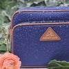 Antitheft water resistant Crissy Full Crossbody. Demonstration of water resistant rubber backed nylon with water running down the fabric. 