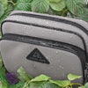 Anti-theft water resistant Crissy Full Crossbody. Demonstration of water resistant YKK zipper and water resistant nylon with water beading and running down the fabric