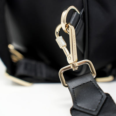 Carmel Convertible Backpack Jacquard Locking Strap Classic Black Gold Closeup Locking View