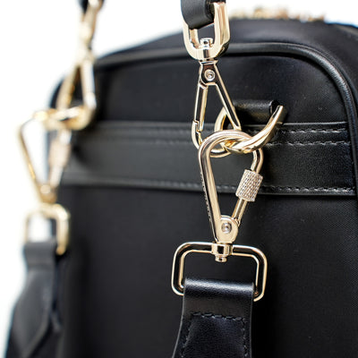 Carmel Convertible Backpack Jacquard Locking Strap Classic Black Gold Closeup View