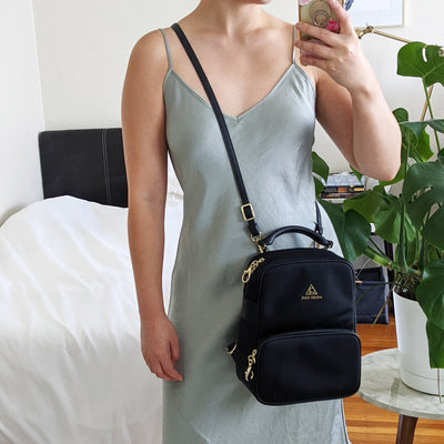 Slash Resistant Faux Leather Strap in Black Gold, modeled with Carmel Backpack as a crossbody